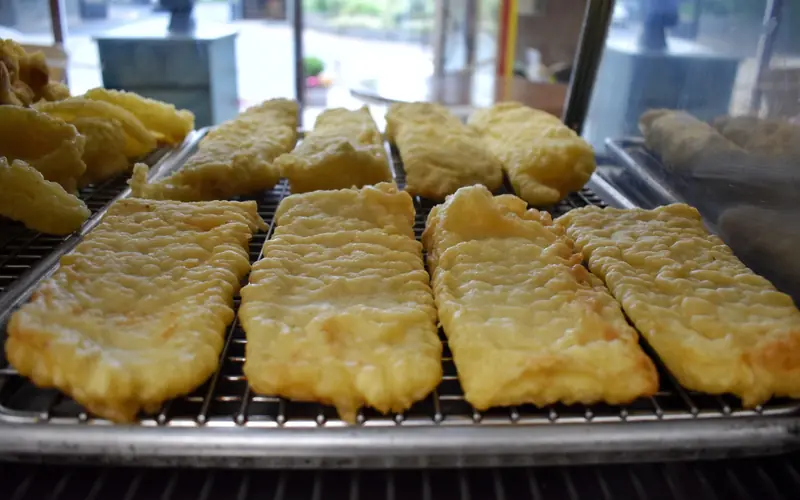 Freshly battered fish on the rack